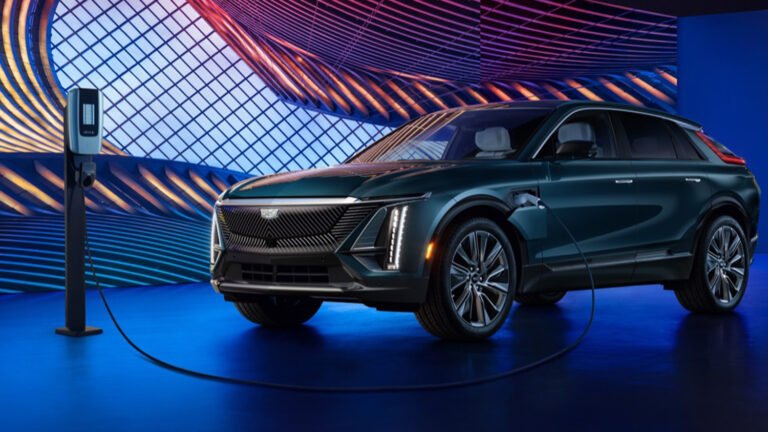 2024-Cadillac-Lyriq-Luxury-450E-Emerald-Lake-Metallic-G6I-Press-Photos-Exterior-012-side-front-three-quarters-charging