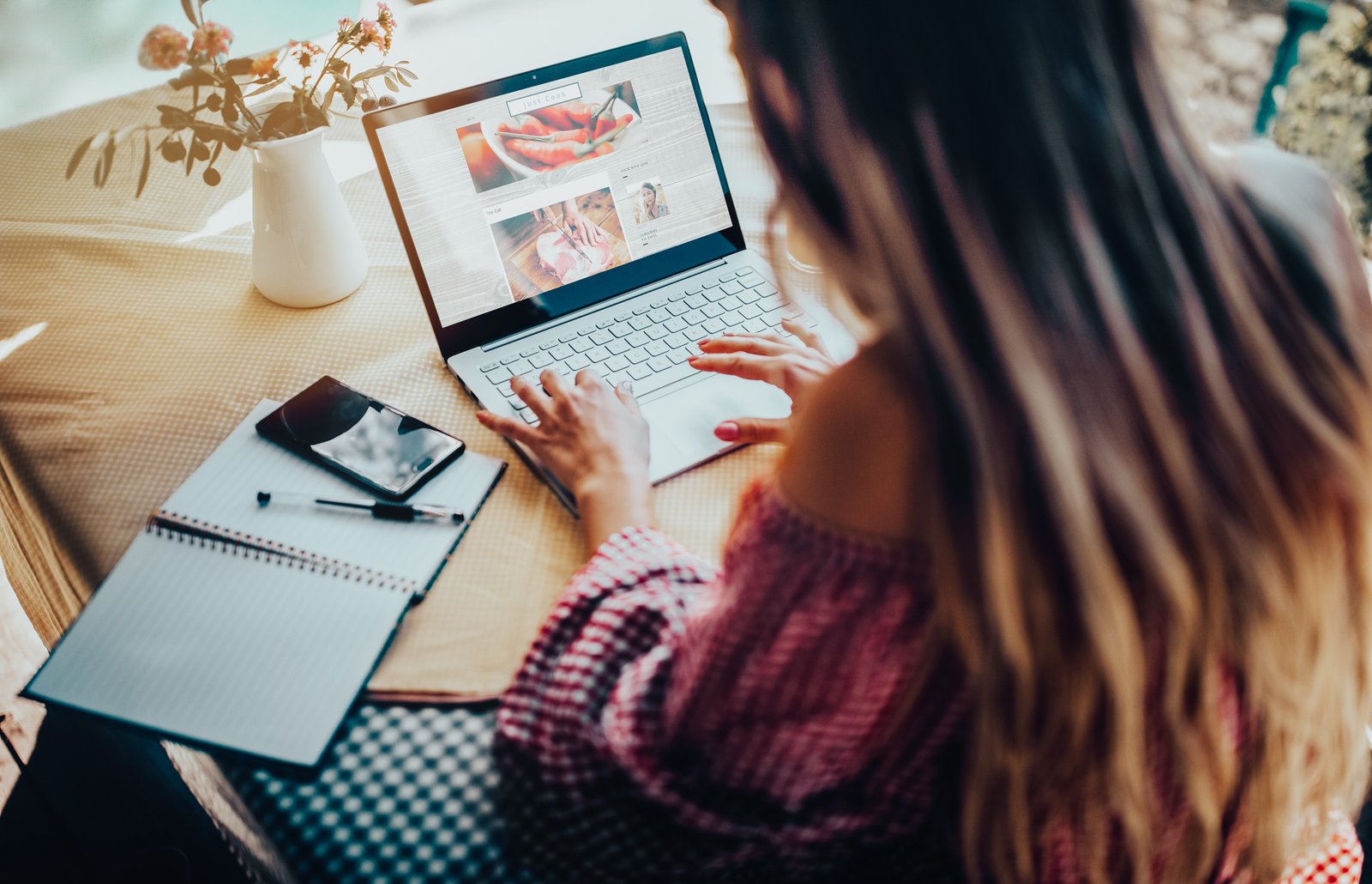 Female food blogger using laptop and working from home